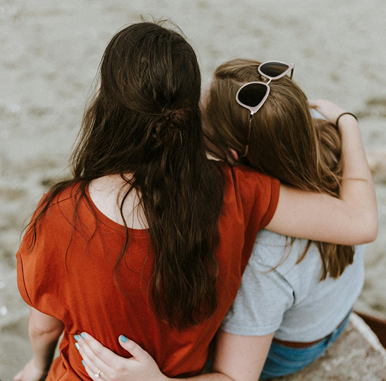 woman-hugging-another-woman